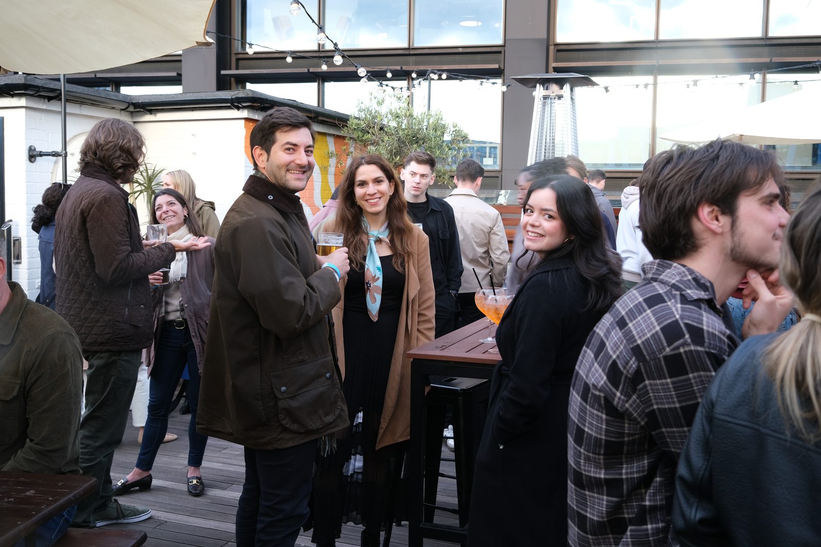 Founders talking over drinks on a rooftop terrace at a Nova Carta gathering